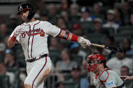 Atlanta Braves outfielder Whit Merrifield (15) hits a double against the Philadelphia Phillies during the fifth inning of a baseball game, Tuesday, Aug. 20, 2024, in Atlanta. (AP Photo/Mike Stewart)