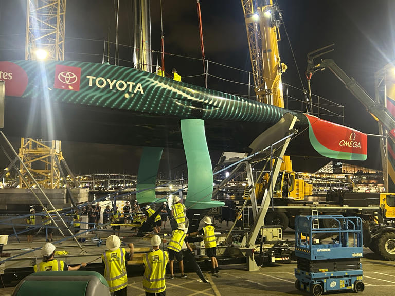 Emirates Team New Zealand inspects the team’s America’s Cup boat after it was damaged when a crane failed while moving it from the water to its cradle after the opening day of racing on Thursday Aug. 29, 2024 in Barcelona, Spain. (AP Photo/Joseph Wilson)