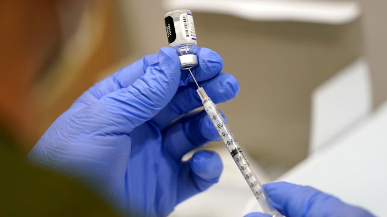 FILE - A healthcare worker fills a syringe with the Pfizer COVID-19 vaccine at Jackson Memorial Hospital, Oct. 5, 2021, in Miami. Three years after COVID-19 vaccines became widely available in the United States, Louisiana continues to debate policies related to inoculation mandates, including civil labilities if a work place mandates vaccines or not and a bill that would prohibit schools from requiring students to receive the vaccine.