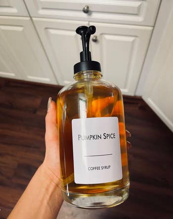 A different reviewer holds a bottle labeled
