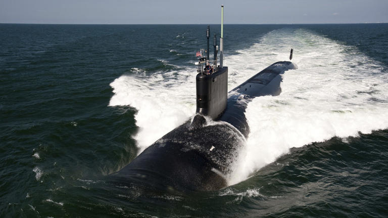 Surfaced submarine sailing through ocean