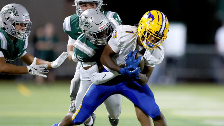 A De La Salle defender tackles Grant's Truman Broadnax from behind during the Spartans' 42-14 opening-week win over Grant. De La Salle moved up from No. 9 to 6 after the victory, while Grant, previously No. 13, dropped to honorable mention | Photo by Dennis Lee