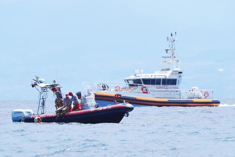 An Italian fire service diving crew off the coast of Porticello, Italy, on Wednesday.