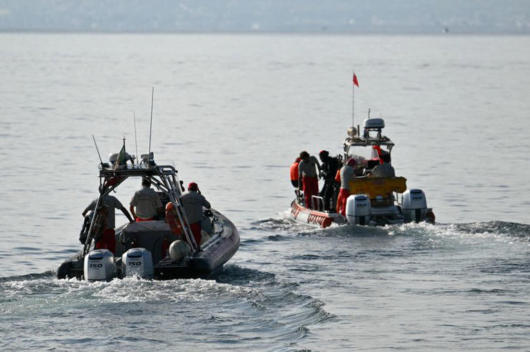 Divers of the Vigili del Fuoco, the Italian Corps. of Firefighters leave Porticello harbor near Palermo