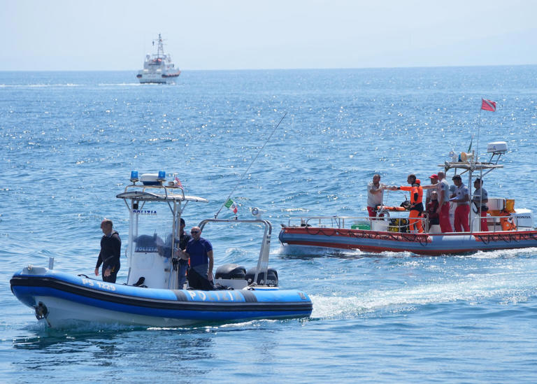 An Italian fire service dive team return to port on the fifth day of the search