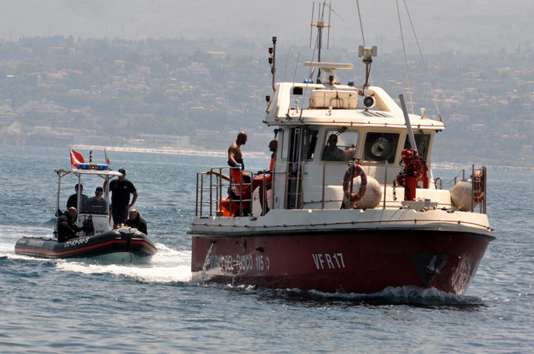 Divers of the Vigili del Fuoco, the Italian Corps. of Firefighters enter Porticello harbor near Palermo. They recovered the body of Hannah Lynch, the last missing person at the back of the boat, on Aug. 23, 2024, four days after the British-flagged luxury yacht Bayesian sank.