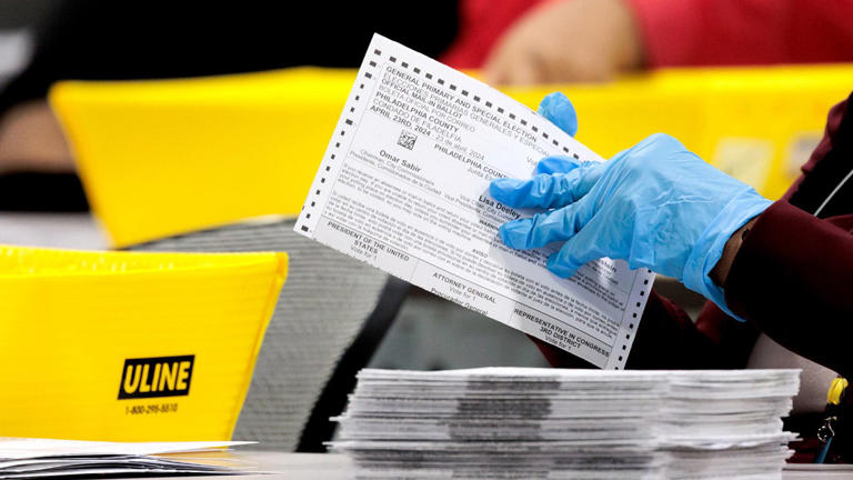 An election worker flattens ballots during the 2024 Pennsylvania primary election at the City of Philadelphia's Election Warehouse in Philadelphia, Pennsylvania, US, on Tuesday, April 23, 2024. Ballot counting could take some time this election, especially with a larger number of mail-in ballots. Getty Images