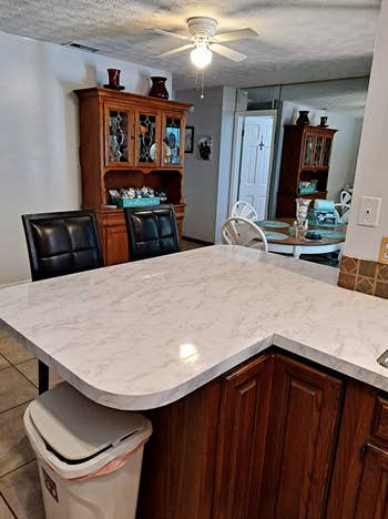 same reviewer showing countertop completely covered in marble contact paper