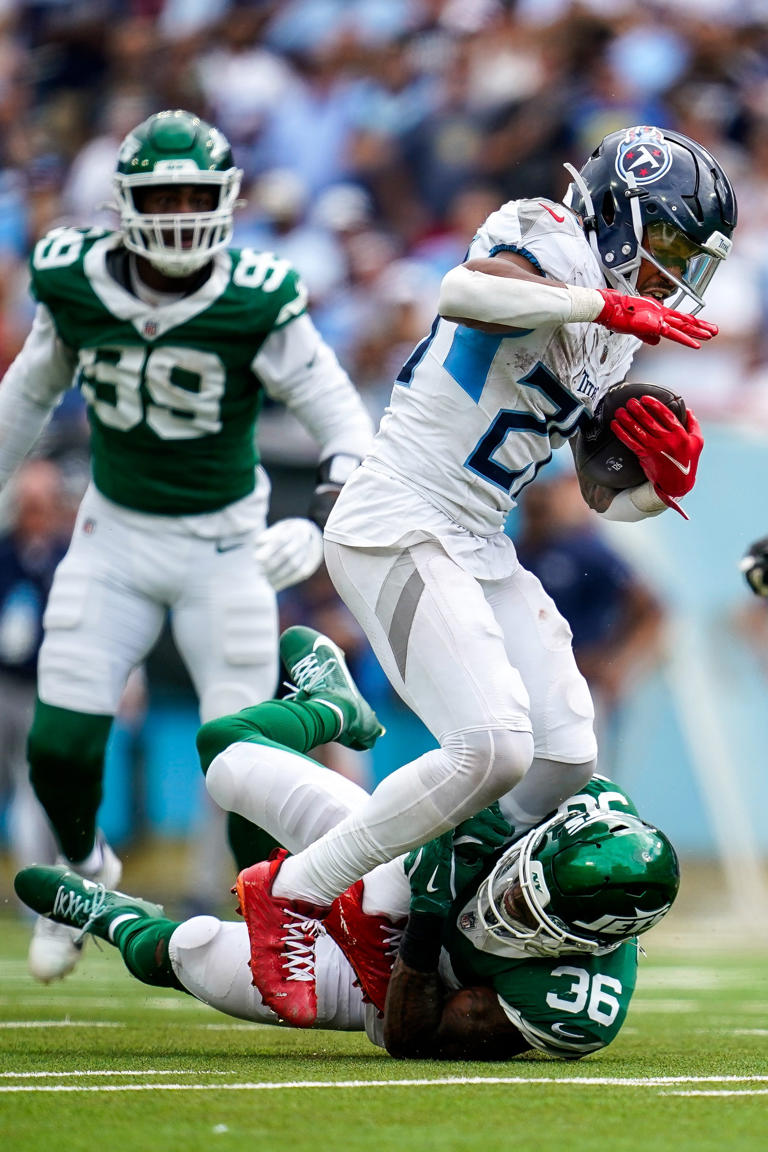 New York Jets safety Chuck Clark (36) trips up Tennessee Titans running back Tony Pollard (20) during the fourth quarter at Nissan Stadium in Nashville, Tenn., Sunday, Sept. 15, 2024.