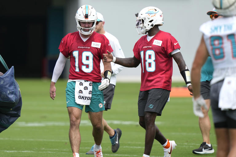 Miami Dolphins quarterbacks Skylar Thompson (19) and Tyler Huntley (18) talk during practice at the NFL football team's training facility, Wednesday, Sept. 18, 2024, in Miami Gardens, Fla. (AP Photo/Lynne Sladky)