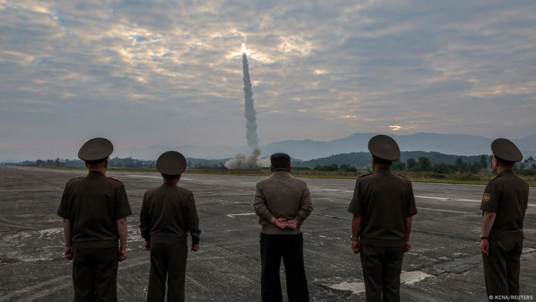 North Korean leader Kim Jong-un looks on during the test of what KCNA described as a new tactical ballistic missile