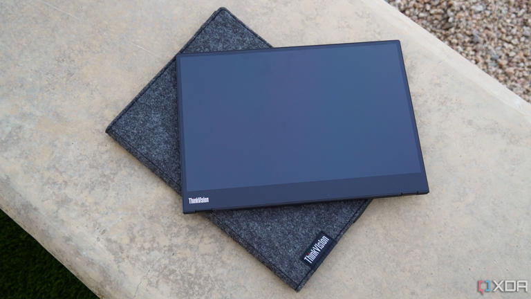 The Lenovo M14T on a concrete bench.