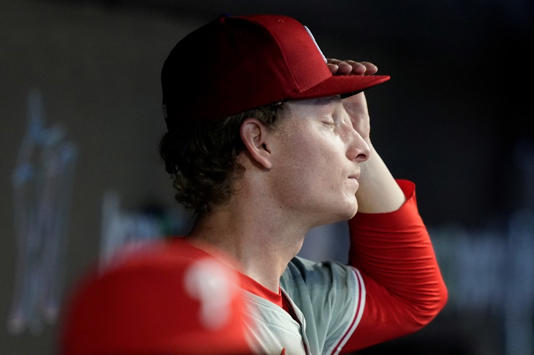 Philadelphia Phillies starting pitcher Seth Johnson stands in the dugout after being relieved during the third inning of a baseball game against the Miami Marlins, Sunday, Sept. 8, 2024, in Miami. (AP Photo/Lynne Sladky)