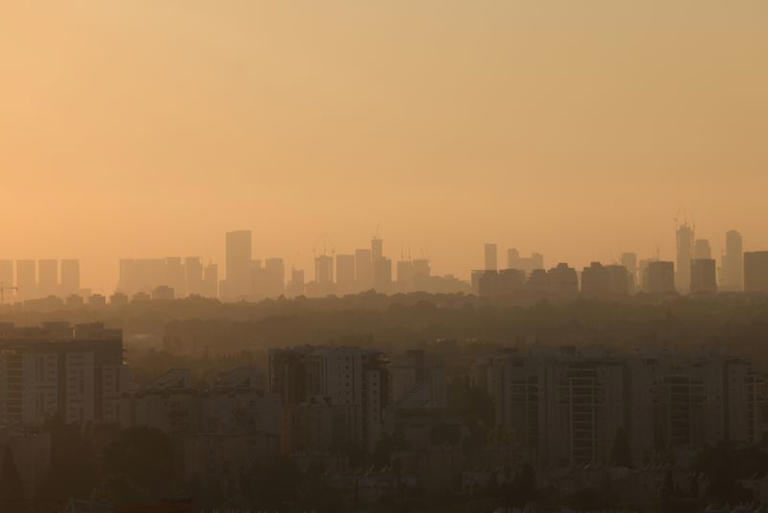 FILE PHOTO: A view of the skyline of Tel Aviv during sunset, as seen from a plane window, Israel, August 18, 2024. REUTERS/Kevin Mohatt/File Photo