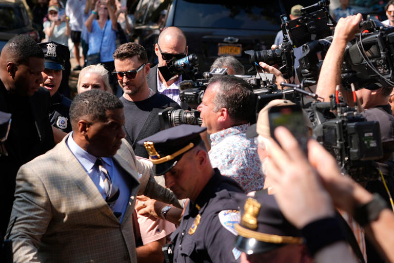 Justin Timberlake is surrounded by media and fans as he enters the courthouse on Friday. AP Photo