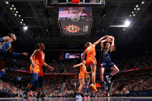 Caitlin Clark #22 of the Indiana Fever drives to the basket during the game against the Connecticut Sun during round one game one of the 2024 WNBA Playoffs