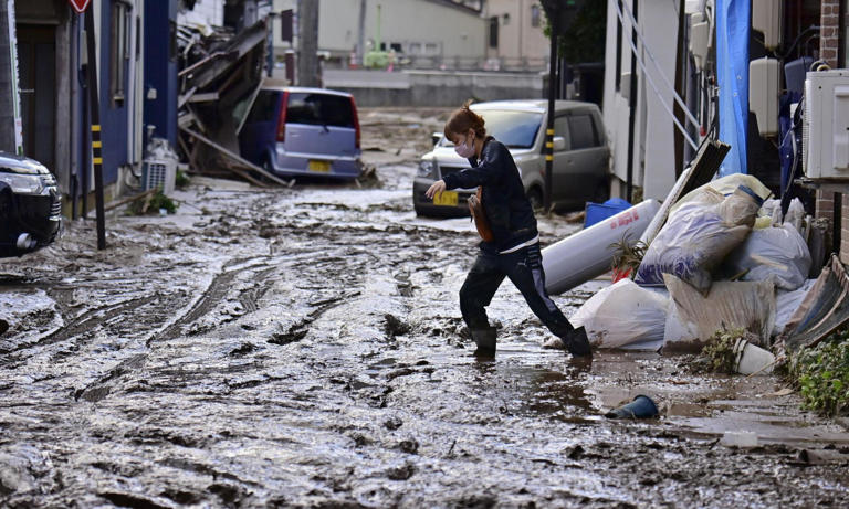 A local resident struggles to walk in mud on the street following floods caused by torrential rain in Wajima, Ishikawa Prefecture, September 22, 2024. Photograph: KYODO/Reuters