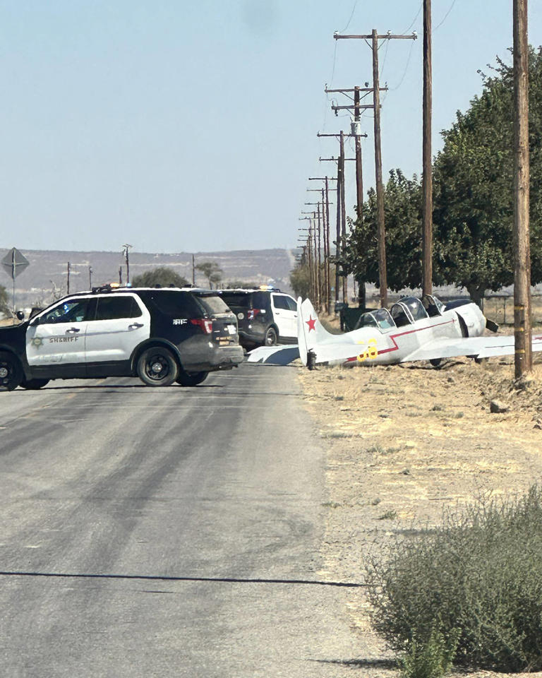 Police officers at the scene of a small plane crash in Lancaster, Calif., on Sunday.
