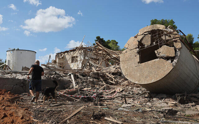 An Israeli man walks past the rubble of a destroyed building in Hod HaSharon in the aftermath of an Iranian missile attack on Israel, on October 2, 2024.(Jack Guez / AFP)