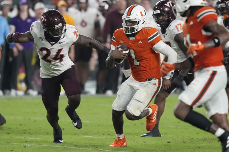 Miami quarterback Cam Ward (1) runs for a touchdown during the second half of an NCAA college football game against Virginia Tech , Friday, Sept. 27, 2024, in Miami Gardens, Fla. (AP Photo/Marta Lavandier)