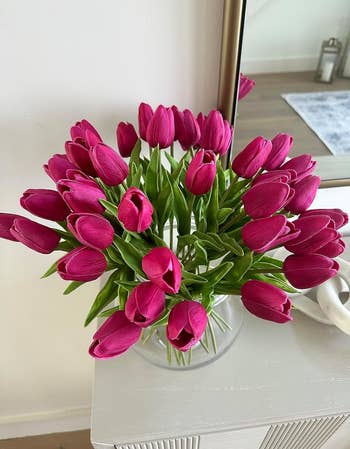 the reviewer's vase of hot pink silk flowers