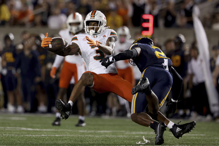 Miami wide receiver Jacolby George (3) is defended by California defensive back Craig Woodson (2) during the first half of an NCAA college football game in Berkeley, Calif., Saturday, Oct. 5, 2024. (AP Photo/Jed Jacobsohn)