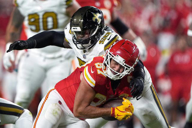 AP Photo/Charlie Riedel Saints' Khalen Saunders collides with Chiefs' Travis Kelce during Monday Night Football at Arrowhead Stadium on October 7, 2024