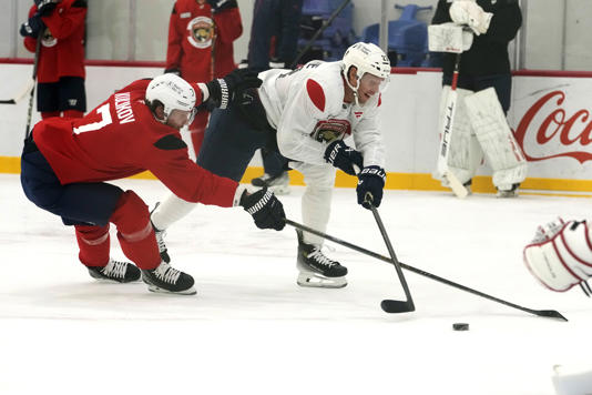 Florida Panthers defenseman Dmitry Kulikov (7) and center Carter Verhaeghe, right, do drills during NHL hockey training camp Thursday, Sept. 19, 2024, in Fort Lauderdale, Fla. (AP Photo/Lynne Sladky)