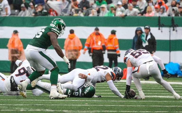 New York Jets quarterback Aaron Rodgers (8) loses the ball as he is sacked by Denver Broncos linebacker Jonah Elliss (52) during the fourth quarter, Sunday, Sept. 29 2024, in East Rutherford, N.J. The Broncos won, 10-9.