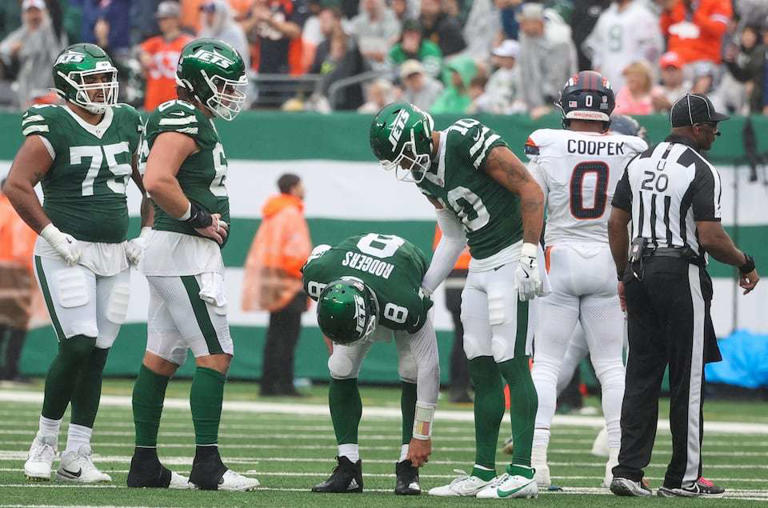 New York Jets quarterback Aaron Rodgers (8) is helped up by wide receiver Allen Lazard (10, right) after Rodgers was sacked during the fourth quarter, Sunday, Sept. 29 2024, in East Rutherford, N.J. The Broncos won, 10-9.