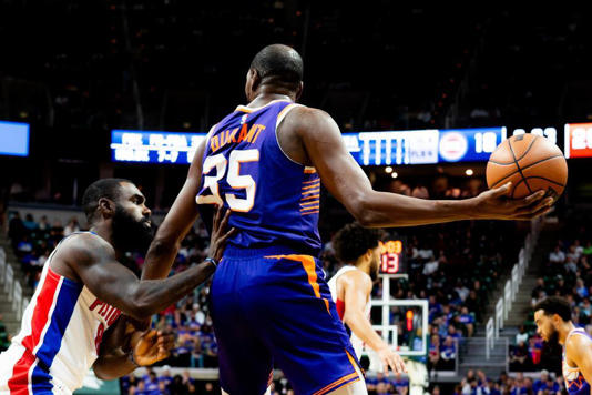 Phoenix forward Kevin Durant (35) keeps the ball out of reach during a NBA preseason game between the Phoenix Suns and Detroit Pistons at the Breslin Center in East Lansing, Michigan, on Tuesday, Oct. 8, 2024.