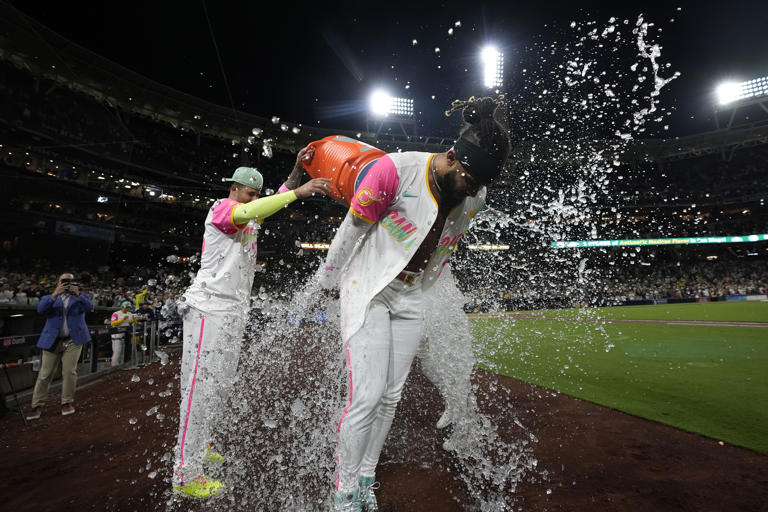 San Diego Padres' Fernando Tatis Jr. is doused after hitting a walk off double during the tenth inning of a baseball game to defeat the Chicago White Sox 3-2, Friday, Sept. 20, 2024, in San Diego. (AP Photo/Gregory Bull)