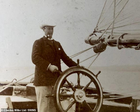 One image from the collection shows a young Churchill smoking a cigar while steering the ship 