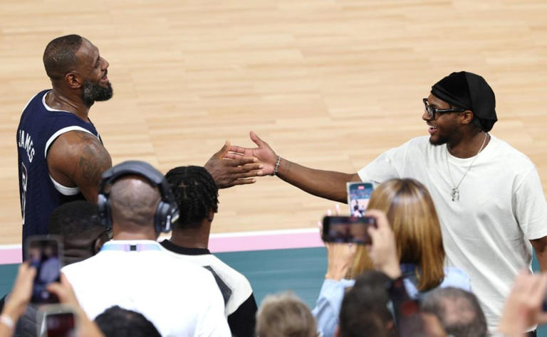 LeBron James #6 of Team United States high fives his son and NBA player Bronny James after Team United States’ victory against Team France during the Men’s Gold Medal game between Team France and Team United States on day fifteen of the Olympic Games Paris 2024 at Bercy Arena on August 10, 2024 in Paris, France. (Photo by Jamie Squire/Getty Images)