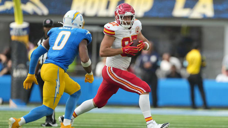 Sep 29, 2024; Inglewood, California, USA; Kansas City Chiefs tight end Travis Kelce (87) runs against Los Angeles Chargers linebacker Daiyan Henley (0) in the second half at SoFi Stadium. Mandatory Credit: Kirby Lee-Imagn Images | Kirby Lee-Imagn Images