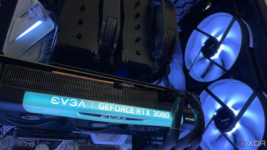 The inside of a PC build, with a black air cooler, EVGA 3080 and large intake RGB intake fans.