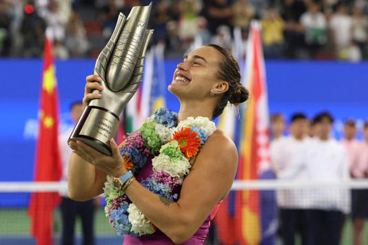 FILE PHOTO: Tennis - Wuhan Open - Optics Valley International Tennis Center, Wuhan, China - October 13, 2024 Belarus' Aryna Sabalenka celebrates with the trophy after winning her final match against China's Qinwen Zheng REUTERS/Florence Lo/File Photo