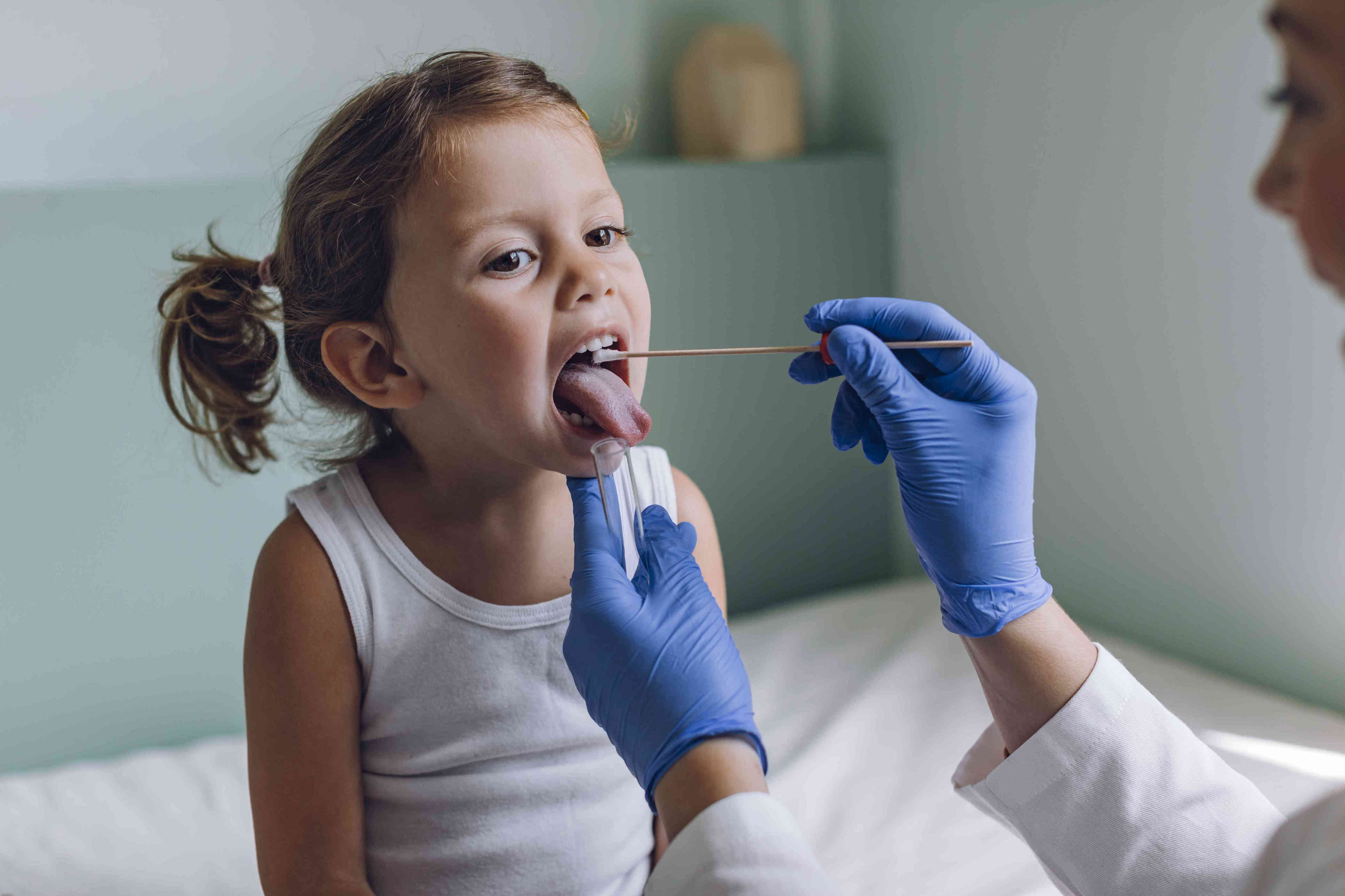 What causes a strawberry tongue?