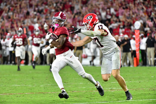 Sep 28, 2024; Tuscaloosa, Alabama, USA; Alabama Crimson Tide wide receiver Ryan Williams (2) evades Georgia Bulldogs quarterback Colter Ginn (17) after a pass reception at Bryant-Denny Stadium. Alabama defeated Georgia 41-34. Mandatory Credit: Gary Cosby Jr.-Imagn Images