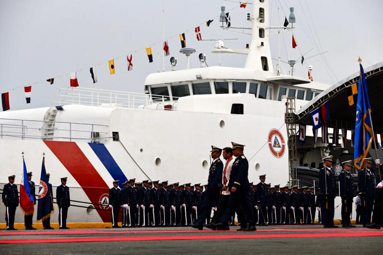 Philippine President Ferdinand Marcos Jnr reviews an honour guard next to the coastguard patrol ship BRP Gabriela Silang in Manila on Tuesday. Photo: EPA-EFE