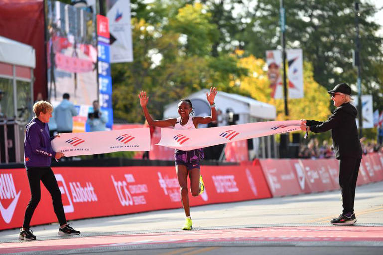 Oct 13, 2024; Chicago, IL, USA; Ruth Chepngetich of Kenya finishes first in the women’s race, setting a new world record at 2:09:56 during the Chicago Marathon at Grant Park. Mandatory Credit: Patrick Gorski-Imagn Images