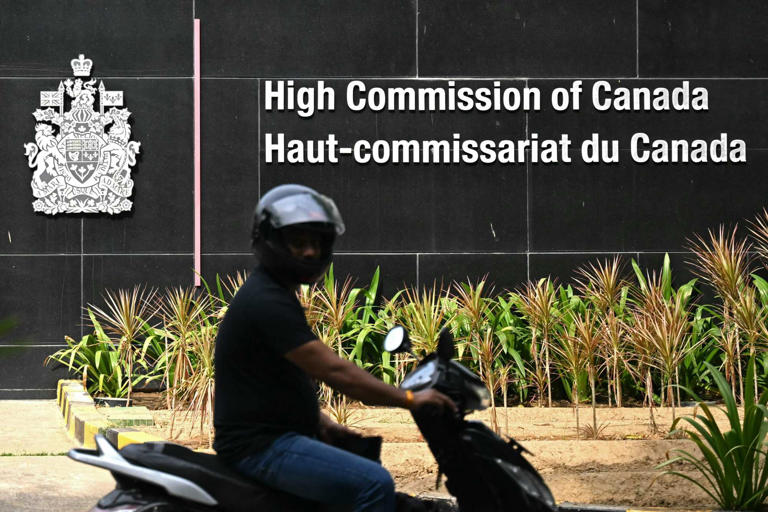 A motorist rides past the entrance of the Canadian High Commission in New Delhi, India, on Wednesday. Photo: AFP