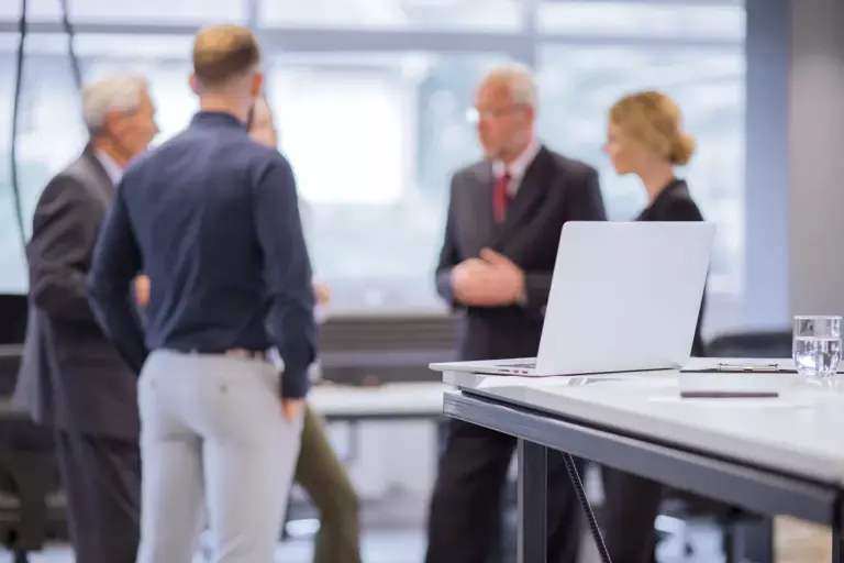 group-business-people-standing-front-laptop-table