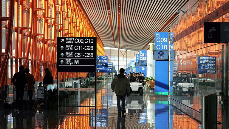 Workers walk through the new Terminal 3 building at Beijing Airport Tuesday Feb. 26, 2008.