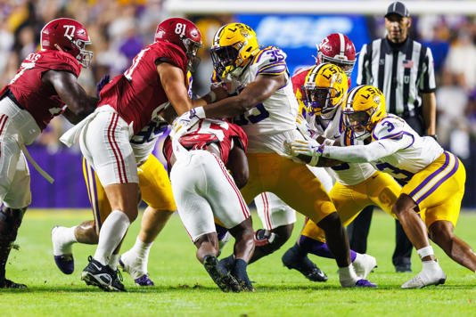 Nov 9, 2024; Baton Rouge, Louisiana, USA; Alabama Crimson Tide linebacker Jeremiah Alexander (35) makes a tackle against Alabama Crimson Tide running back Jam Miller (26) at Tiger Stadium. Mandatory Credit: Stephen Lew-Imagn Images