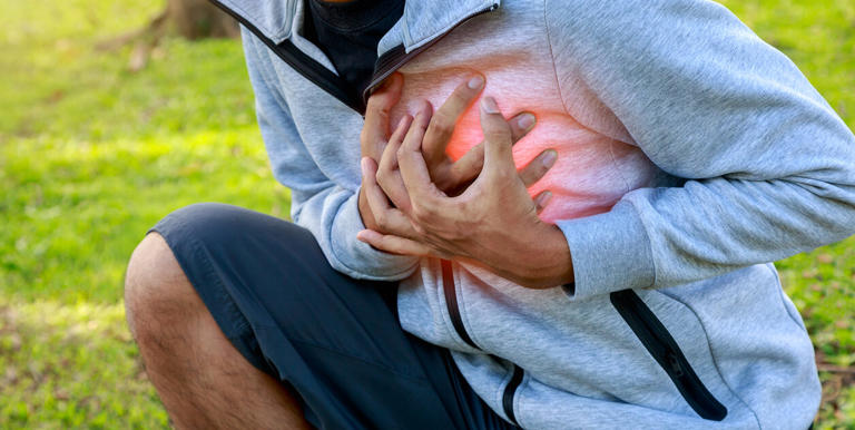 Man having heart attack or heart failure after running at park, Exhausted, tired, illness or over train concept