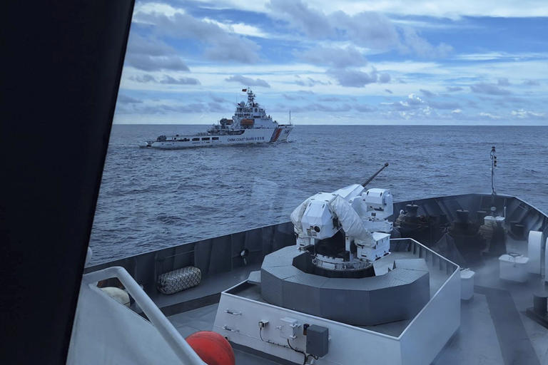 An Indonesian coastguard ship shadows a Chinese coastguard vessel in North Natuna waters in the South China Sea on October 25. Photo: AP