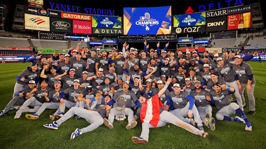 Oct 31, 2024; New York, New York, USA; The Los Angeles Dodgers pose for a picture with the Commissioner’s Trophy after beating the New York Yankees in game four to win the 2024 MLB World Series at Yankee Stadium. Mandatory Credit: Brad Penner-Imagn Images | Brad Penner-Imagn Images