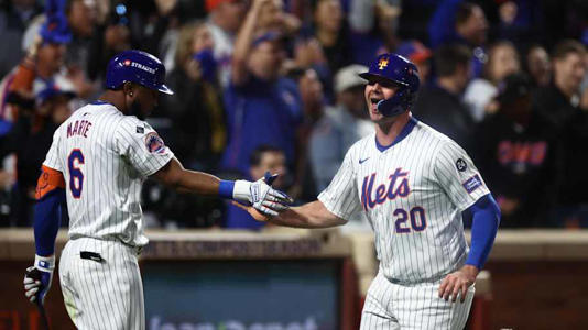 Oct 18, 2024; New York City, New York, USA; New York Mets first baseman Pete Alonso (20) high-fives right fielder Starling Marte (6) after scoring during the fourth inning against the Los Angeles Dodgers during game five of the NLCS for the 2024 MLB playoffs at Citi Field. | Vincent Carchietta-Imagn Images