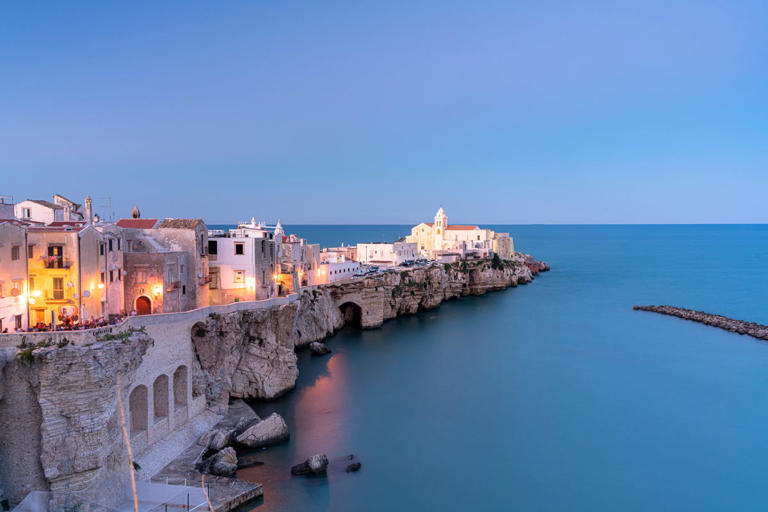 Old town of Vieste by sea at dusk, Puglia, Italy